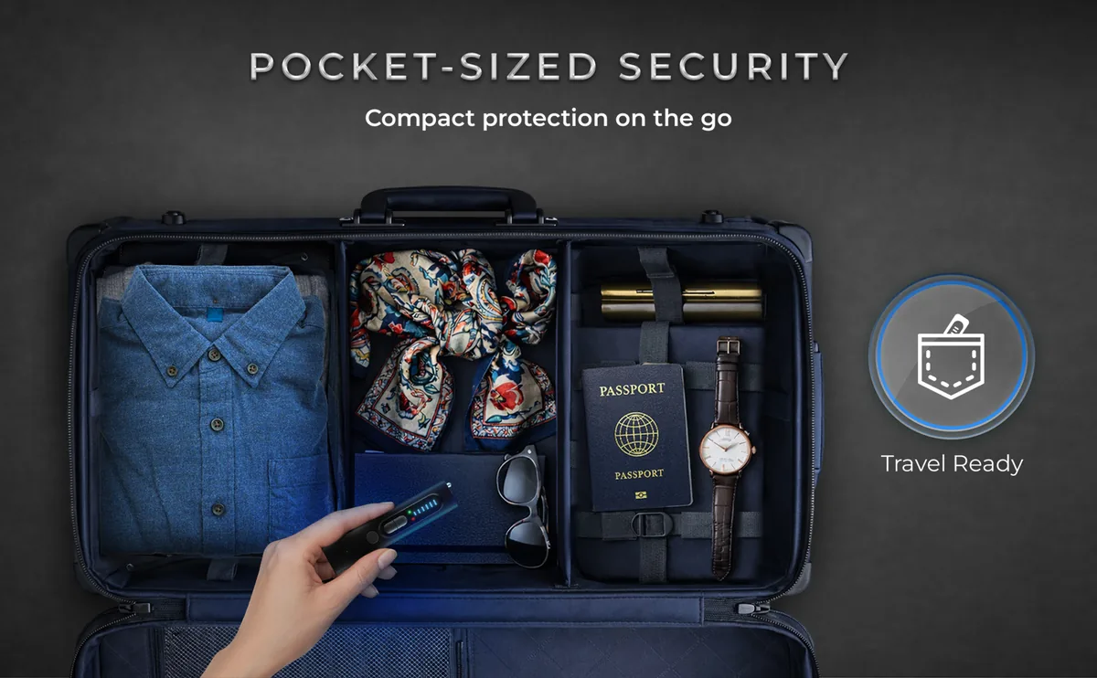 A hand placing the VLV13 into a packed suitcase next to a passport and sunglasses